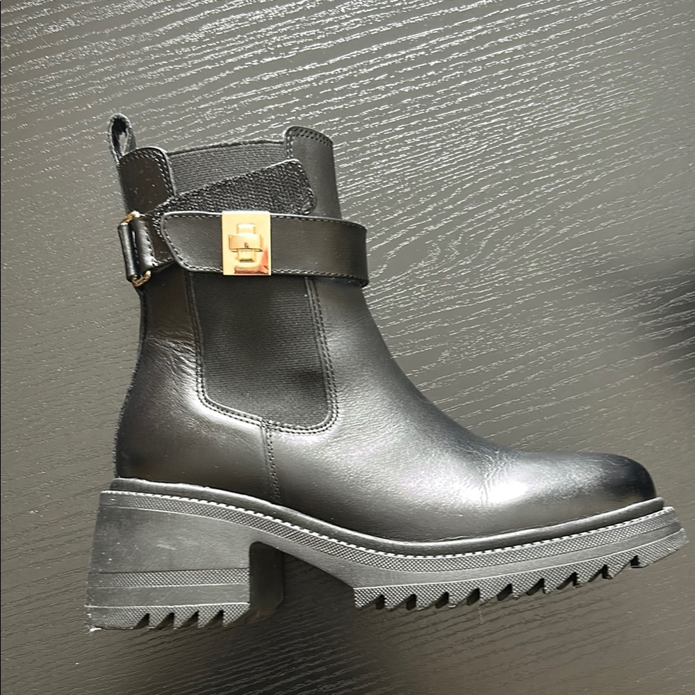 Steve Madden Black Leather Ankle Boots with gold accent.